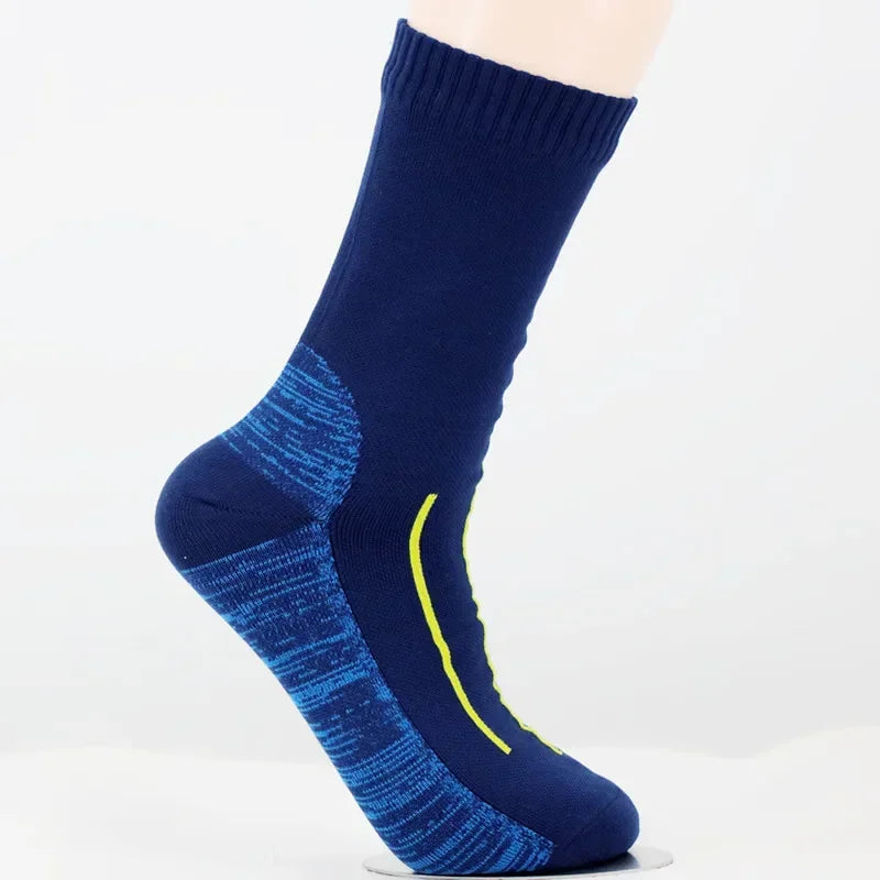 A close-up of a navy blue waterproof breathable hiking sock with bright yellow accents.