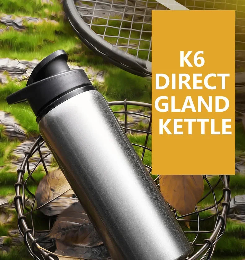 A silver K6 direct gland kettle is shown in a mesh basket amidst green foliage.