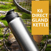 A silver K6 direct gland kettle is shown in a natural outdoor setting with leaves and a wire basket.