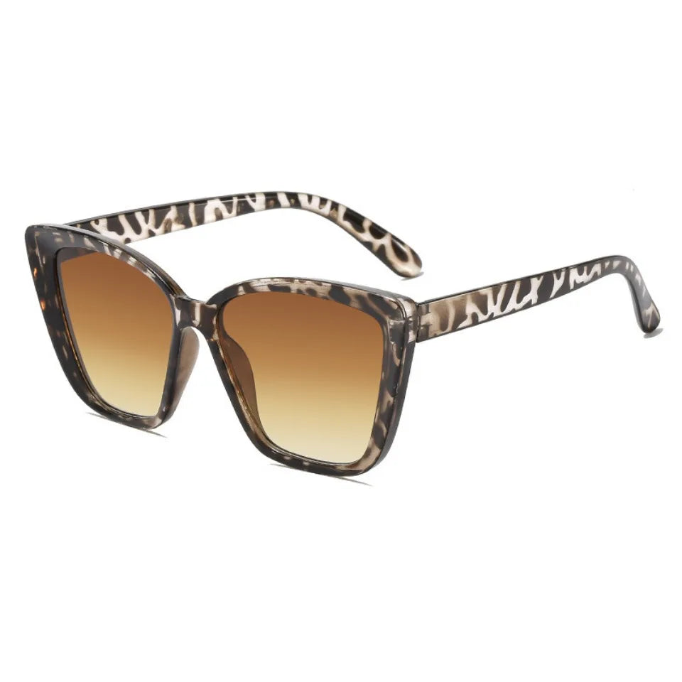 Pair of tortoiseshell cat eye vintage sunglasses with gradient brown lenses.