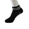 Black non-slip grip socks with silver stripes and small perforations