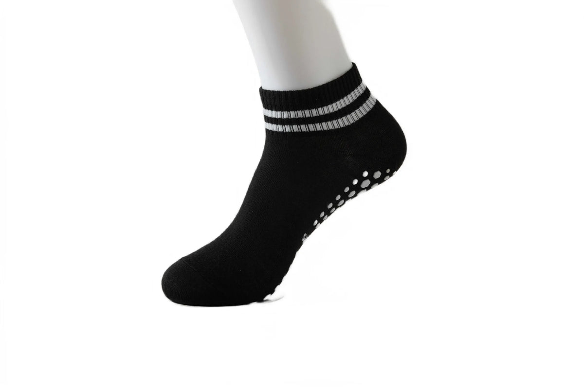 Black non-slip grip socks with silver stripes and small perforations