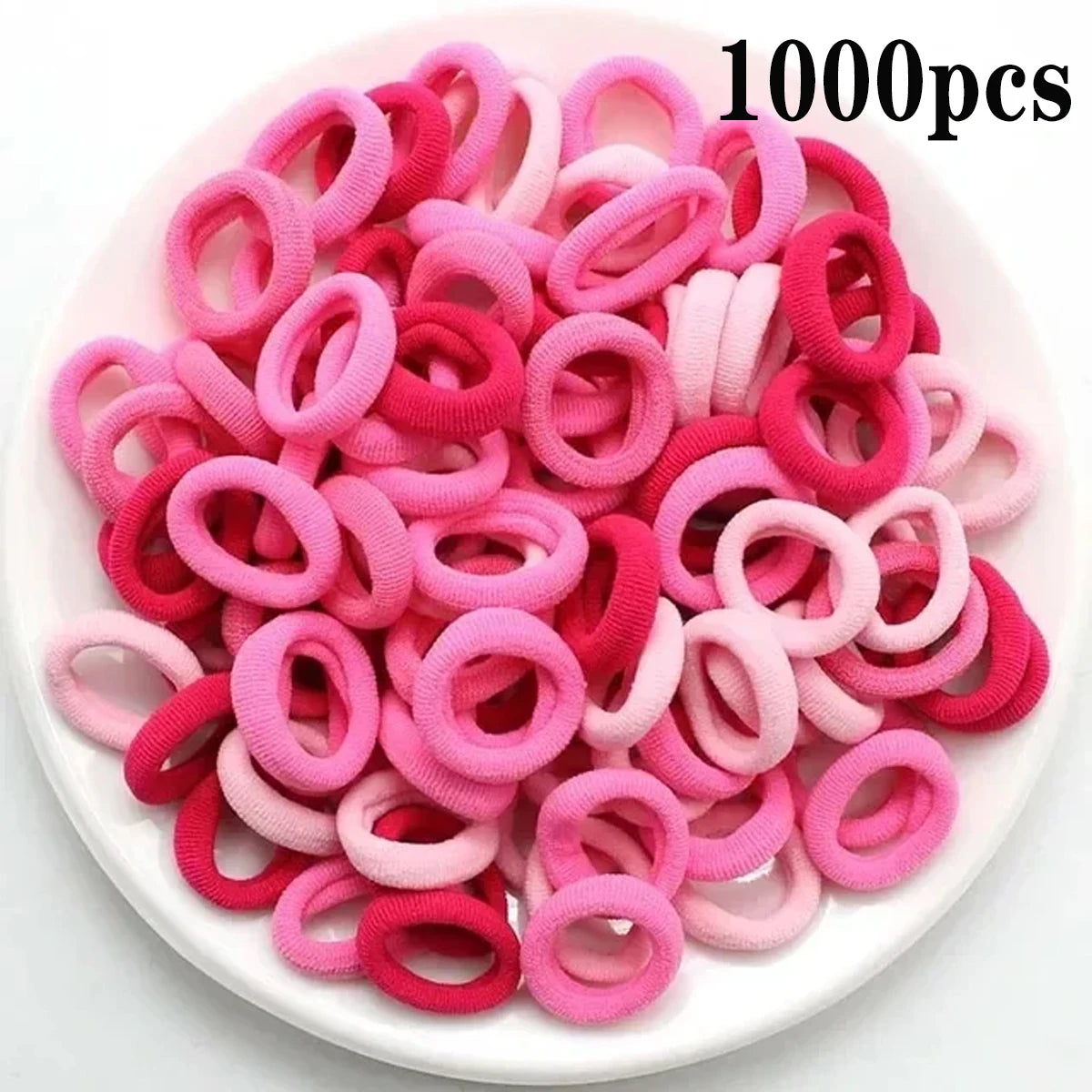 Haufen von 1000 rosa und roten Nylon-Elasthebändchen für Pferdeschwänze und Zöpfe.