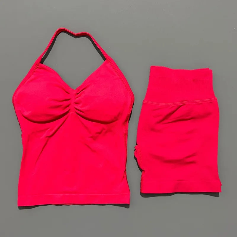 A bright pink women's seamless backless fitness set top and bottom shown against a gray background.