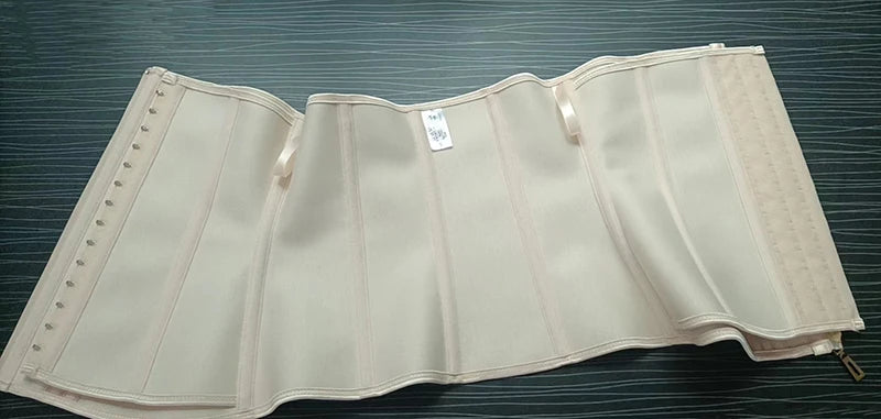 A beige double compression waist trainer corset body shaper displayed flat on a dark surface.