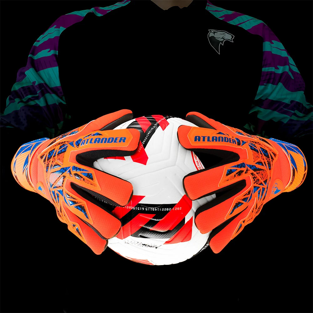 Orange and black latex goalkeeper gloves with a wrist strap shown against a dark background.