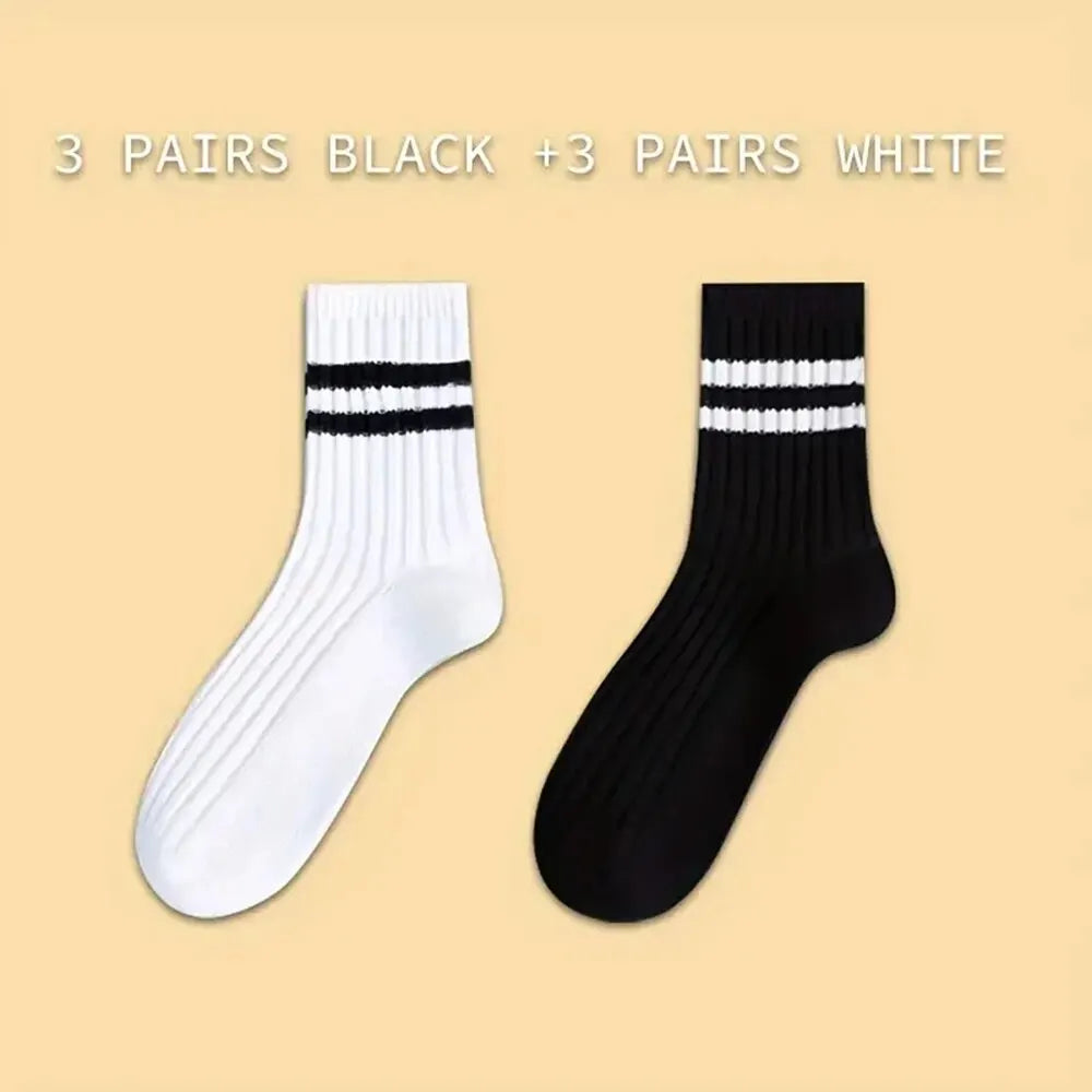 Präsentation von sechs Paar gemusterter, atmungsaktiver Herrensocken, drei schwarz und drei weiß.