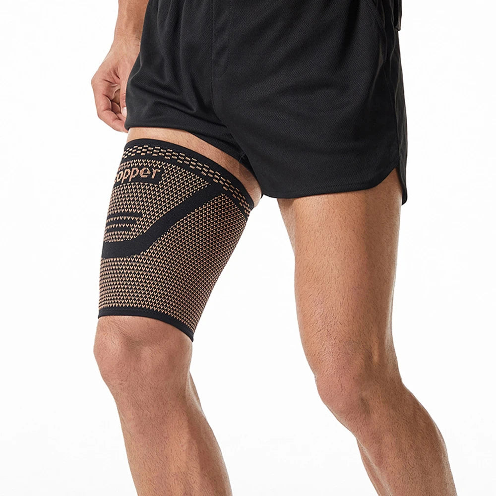 Black anti-slip copper thigh compression sleeves worn on a person's leg.