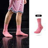 Pink performance basketball running socks shown on a person's leg.