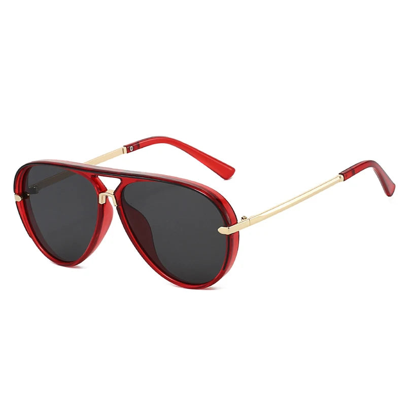 Red-framed retro pilot sunglasses with gradient lenses and gold accents