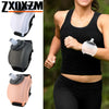 A woman is exercising while wearing a black tank top and black leggings, holding a clear silicone hydration bottle on her wri