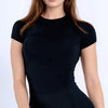 A woman wearing a black performance fitness short sleeve top.