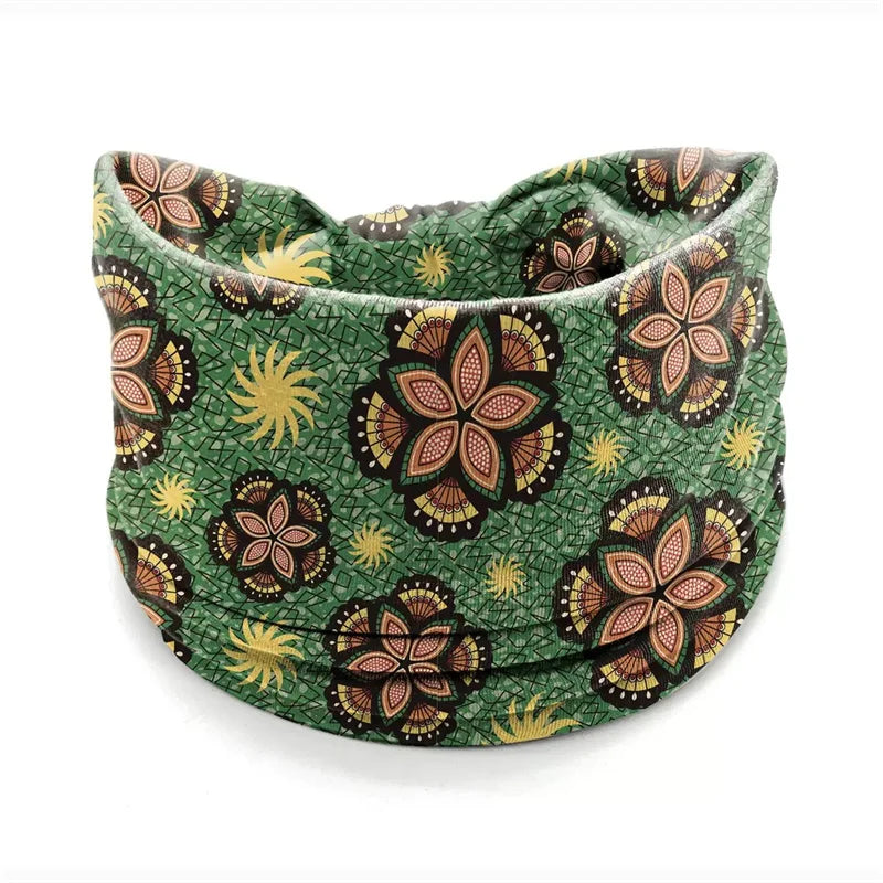 A green bohemian stretch cotton headband featuring a pattern of orange and yellow floral designs.