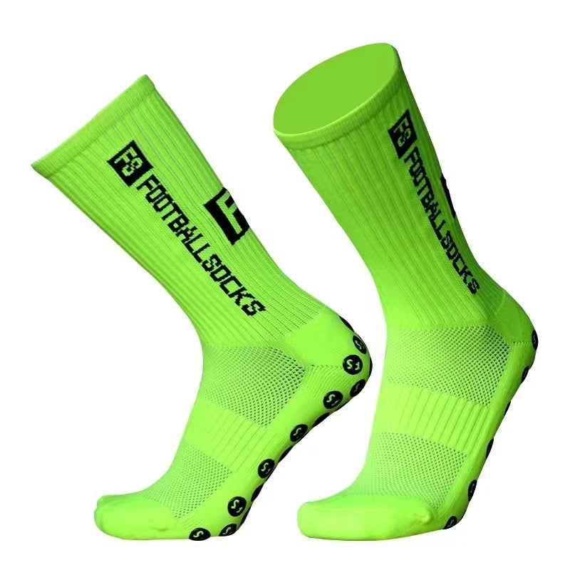 A pair of neon green anti-slip silicone grip football socks shown from the side.
