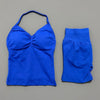 A royal blue women's seamless fitness set consisting of a cropped top and matching capri-length bottoms.