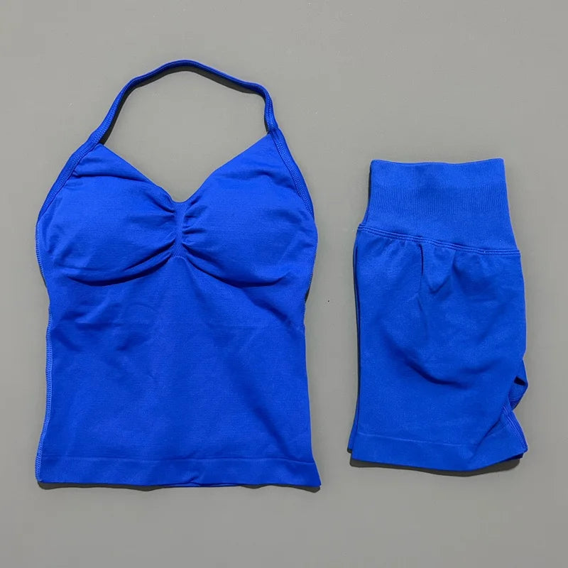 A royal blue women's seamless fitness set consisting of a cropped top and matching capri-length bottoms.