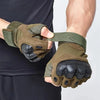 A pair of olive green tactical five-finger gloves being held by a person against a dark background.