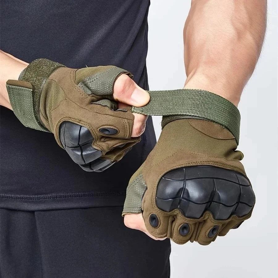 A pair of olive green tactical five-finger gloves being held by a person against a dark background.