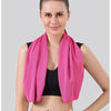 A woman models a bright pink instant cooling towel for sports and fitness.