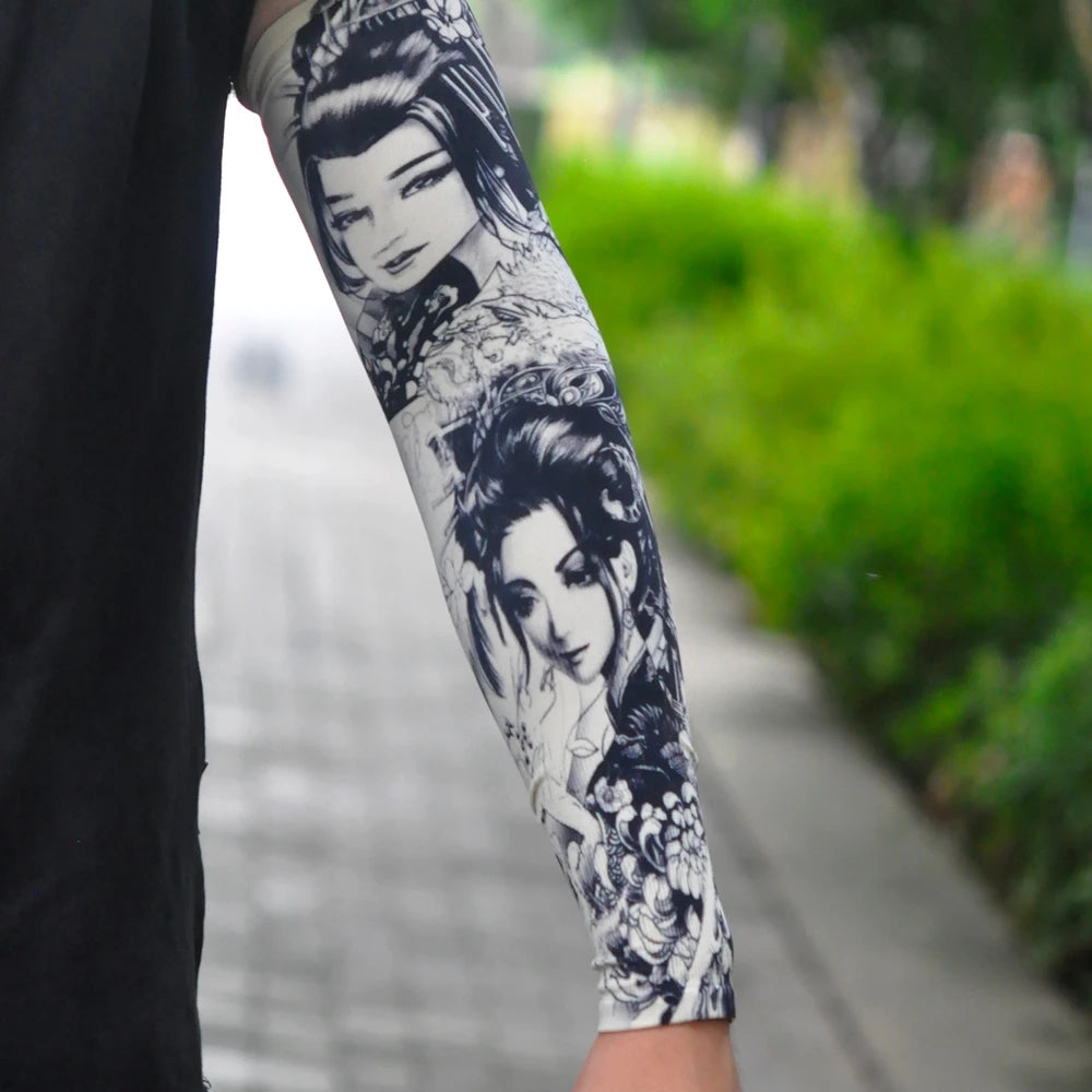 Close-up of a person's arm displaying intricate black and gray traditional Asian-style tattoo sleeve designs.