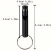 A black aluminum survival whistle keychain with a cylindrical body and a circular loop.