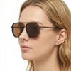 Close-up of a woman wearing brown aviator style sunglasses