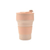 A beige reusable silicone collapsible coffee cup with a matching lid.