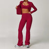 A woman models a three-piece maroon yoga sports set consisting of a cropped top, leggings, and a jacket.