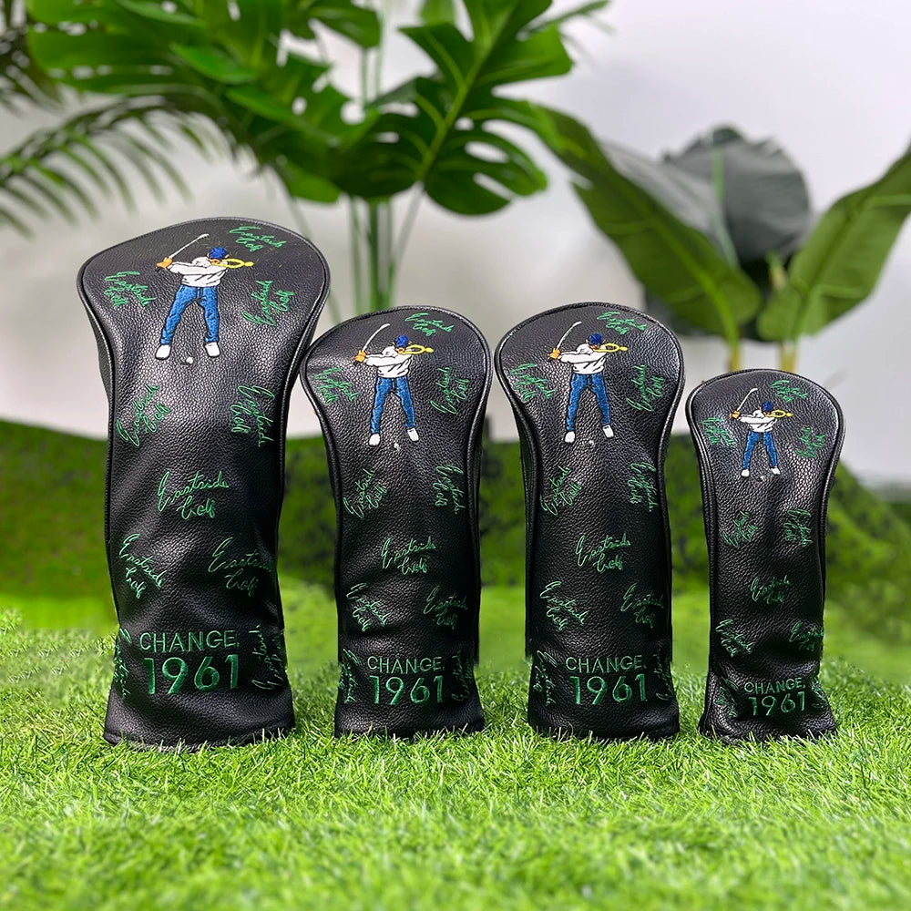 A set of four black golf club head covers featuring a silhouette of a golfer and the text CHANGE 1961 on a green grassy surfa
