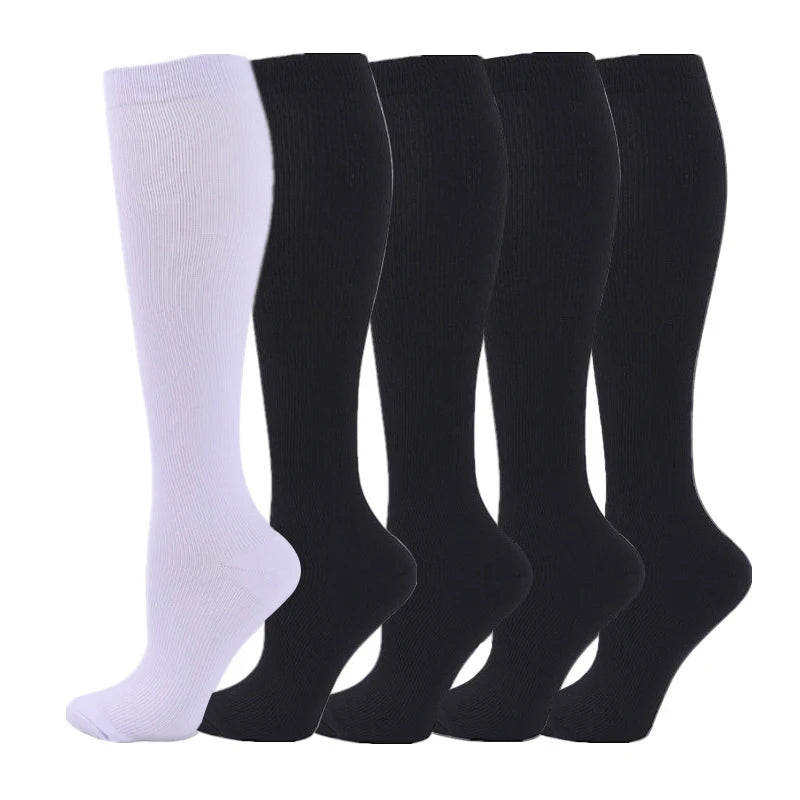 A set of black and white medical grade compression socks for veins and sports