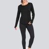 A woman models a black loose fit sun protection t-shirt and black leggings.