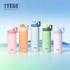 A row of five TYESO insulated stainless steel water bottles in various pastel colors standing on a light blue surface.