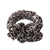 A black and brown leopard print heatless curling rod headband tied in a voluminous knot.