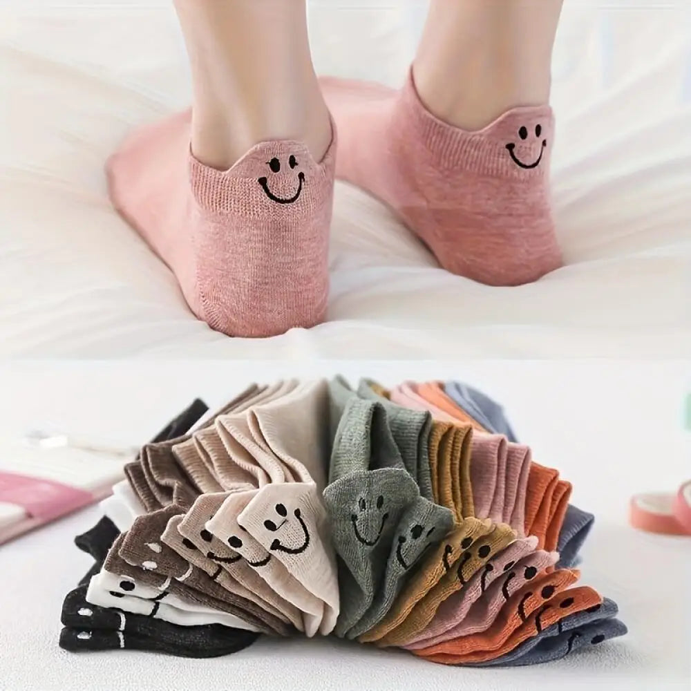 Eight pairs of low-cut ankle socks with smiling embroidery in various muted colors