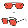 Un par de gafas de sol de color rojo brillante con montura negra, mostradas en dos vistas.