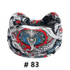 A close-up of a black and red bohemian print cotton headband for hair or workout.