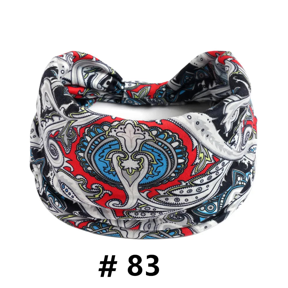 A close-up of a black and red bohemian print cotton headband for hair or workout.