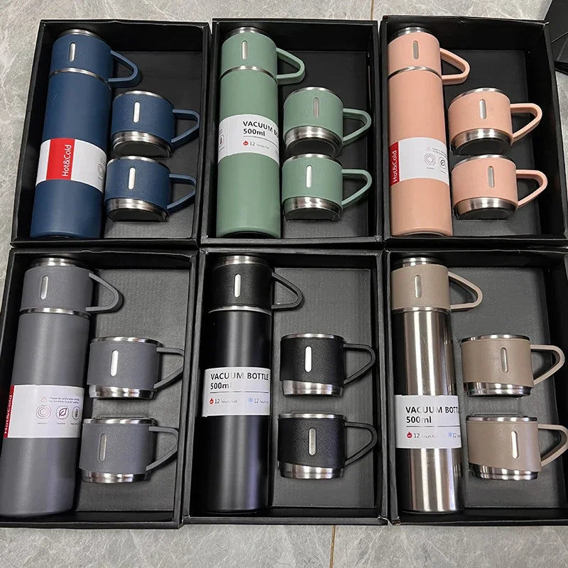 A collection of 12 stainless steel vacuum flasks in various colors and finishes displayed in individual compartments.