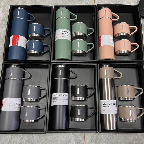 A collection of 12 stainless steel vacuum flasks in various colors and finishes displayed in individual compartments.