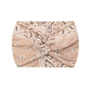 A beige boho printed wide knotted headband with intricate paisley patterns.
