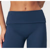 A close-up of a navy blue high-waist yoga and fitness legging worn by a model.