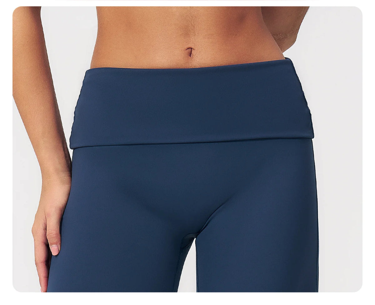 A close-up of a navy blue high-waist yoga and fitness legging worn by a model.