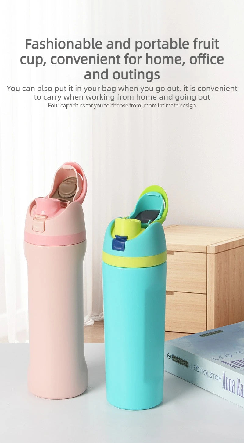 A pink and blue insulated stainless steel water bottle with a dual drinking spout sitting on a white surface.