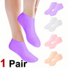 A pair of purple silicone moisturizing socks and several white, pink, and beige silicone socks are displayed on a person's fo