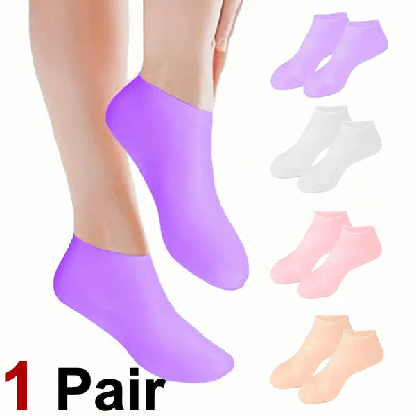 A pair of purple silicone moisturizing socks and several white, pink, and beige silicone socks are displayed on a person's fo