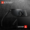 A pair of black frameless sports sunglasses resting on a dark, textured surface.