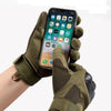 A hand wearing olive green tactical sports gloves holding a smartphone displaying an app interface.