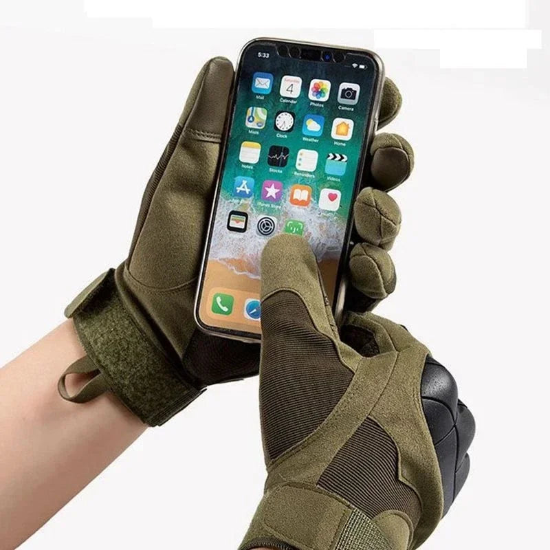 A hand wearing olive green tactical sports gloves holding a smartphone displaying an app interface.