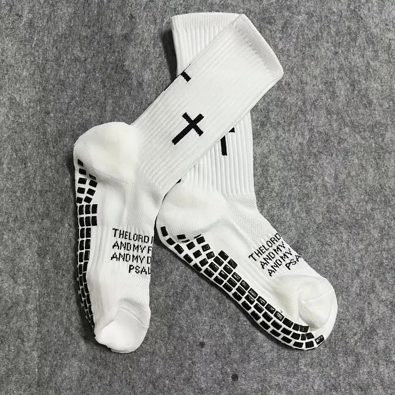 A pair of white athletic socks with black cross patterns and text printed on the foot.