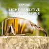A pair of photochromic cycling sunglasses with a warm amber tint resting on a textured stone surface.